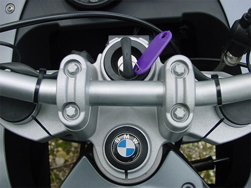 image of a BMW motorcycle with a newly-cut key in the ignition lock